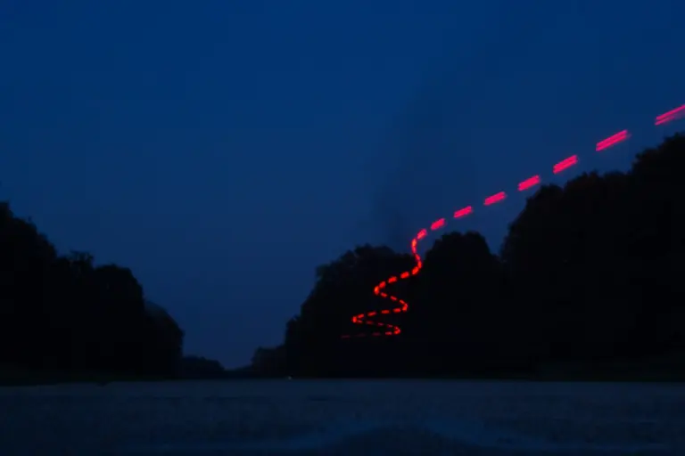 a long exposure photo of a road at night